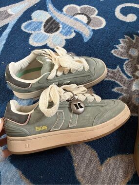 Coolway Bolk suede sneakers in a mossy green color, with brown and white laces